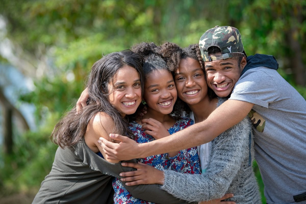 A group of friends embracing outdoors